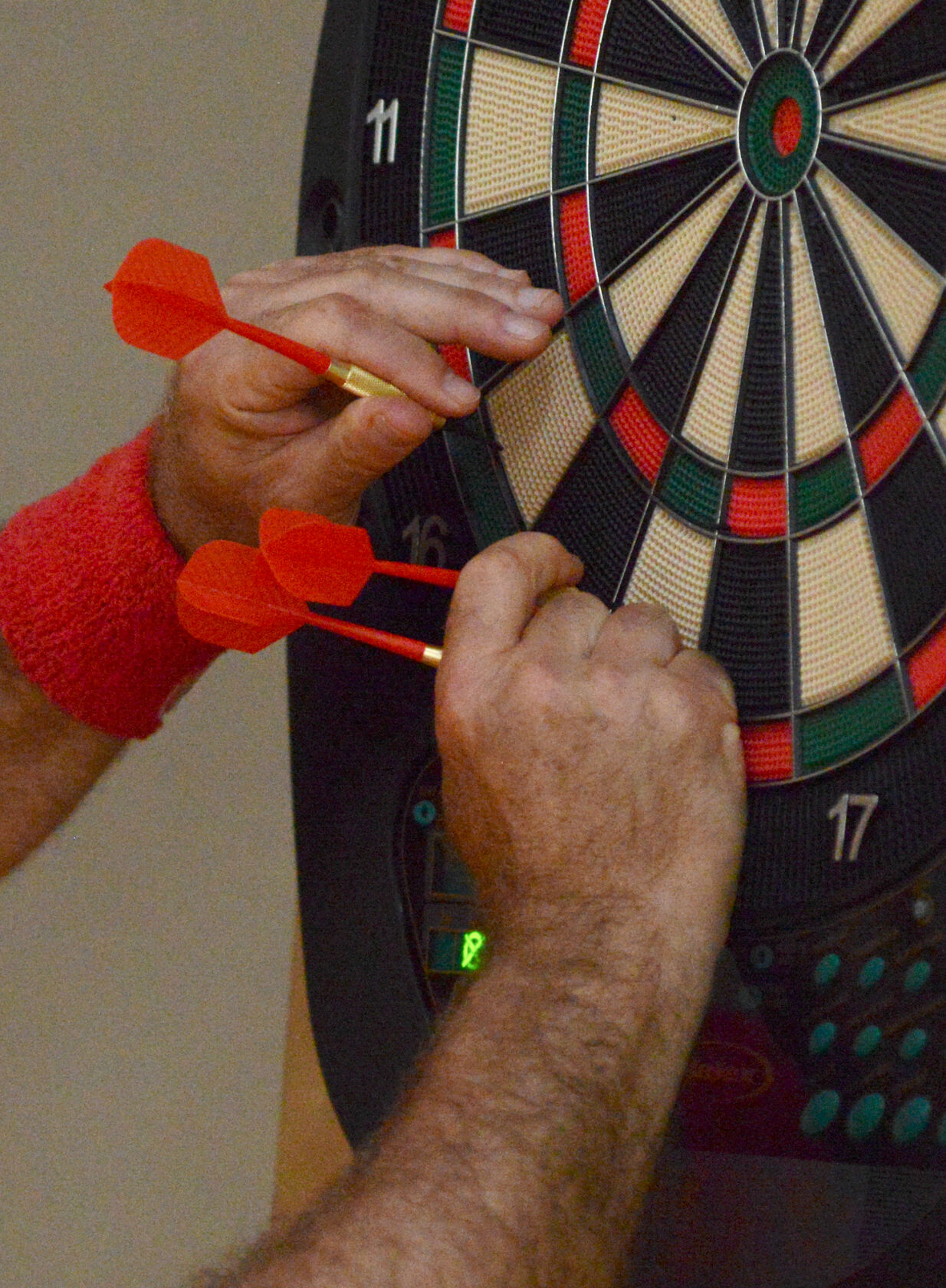 Scott Schwartz pulls darts out of the board
